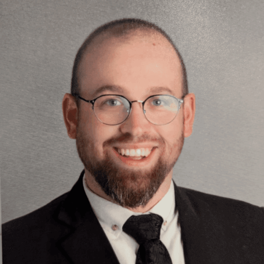 Smiling bearded man in suit and tie