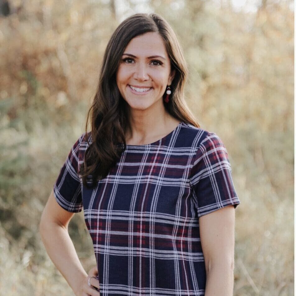 Smiling woman in plaid dress outdoors