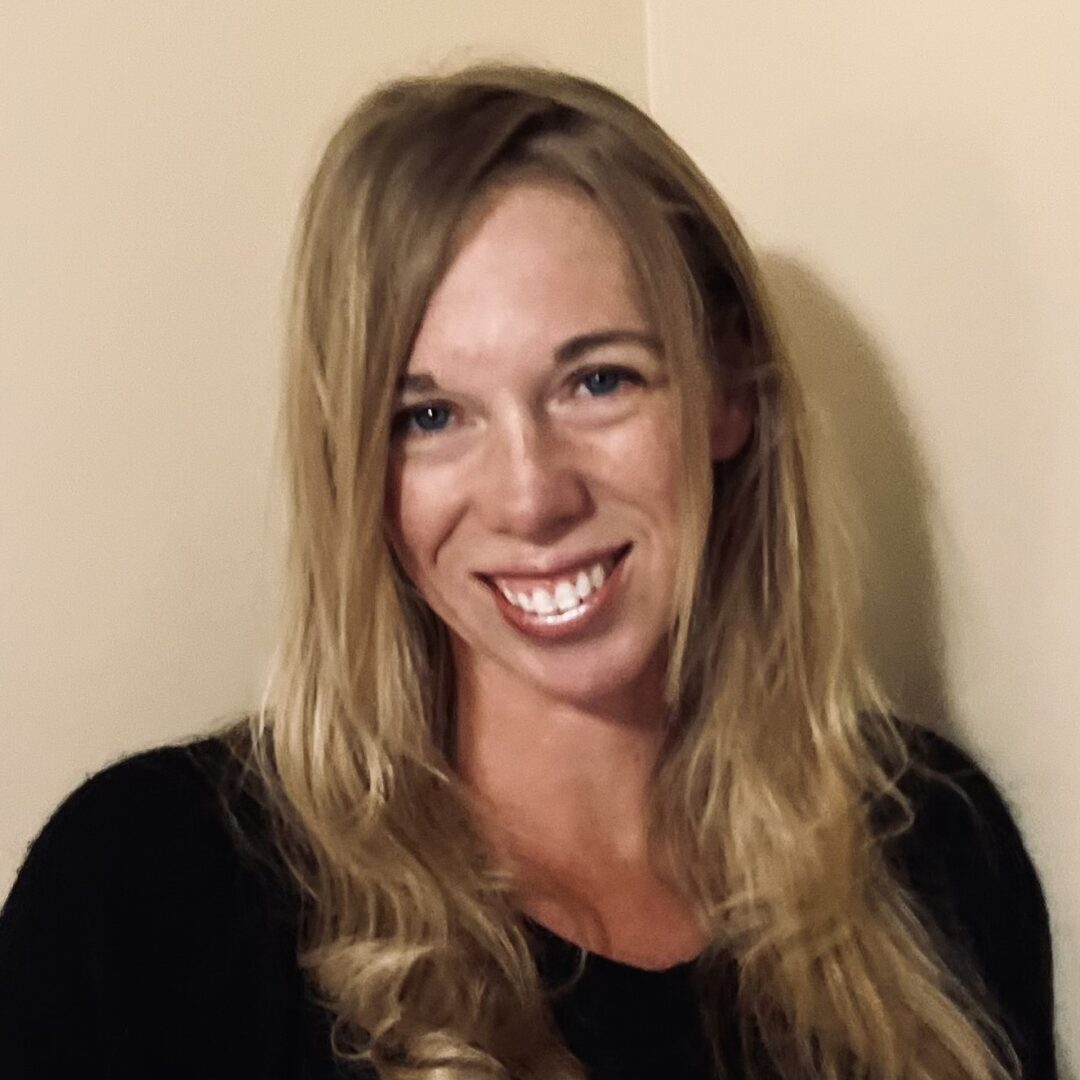 Smiling woman with long blonde hair.