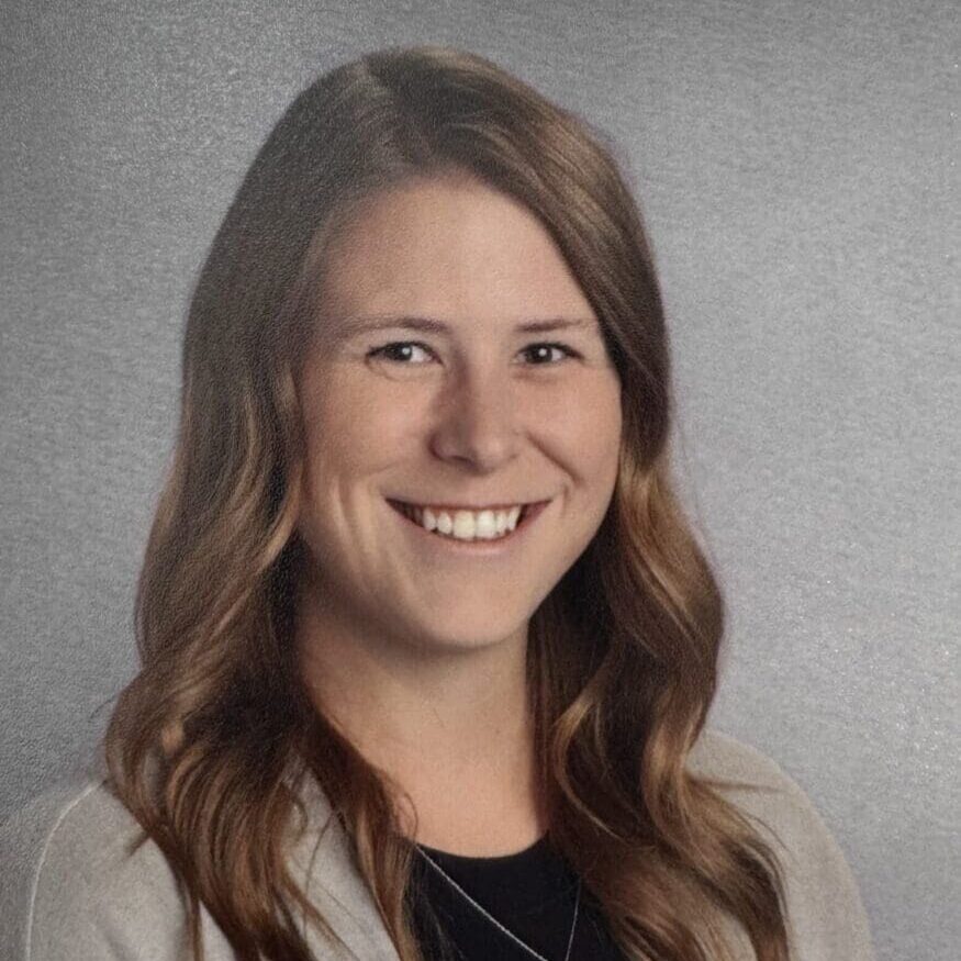 Smiling woman with wavy hair in blazer
