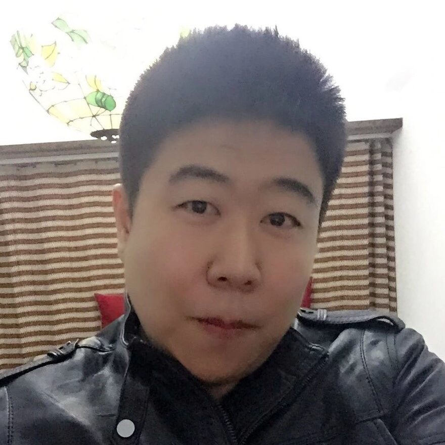 Headshot of a man in a leather jacket.