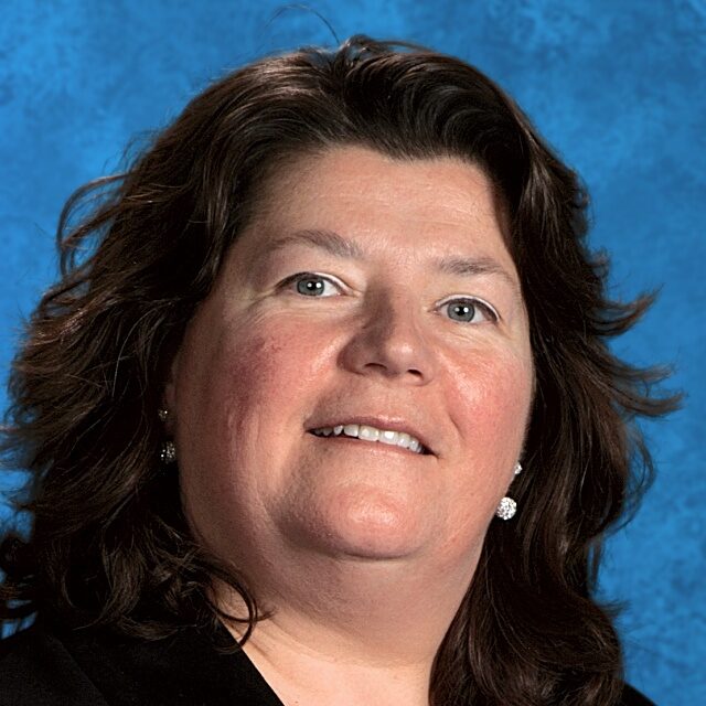 Headshot of a woman with brown hair.