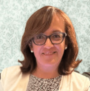 Smiling professional woman wearing glasses and blazer