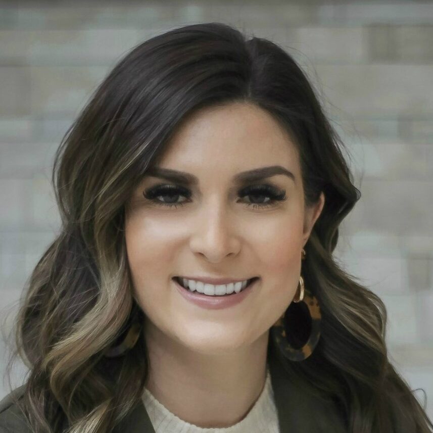 Woman with long brown hair and earrings.